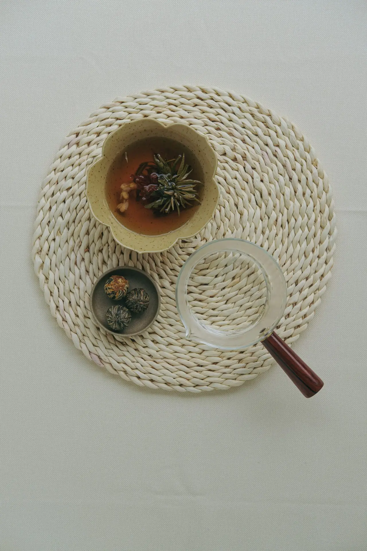 a bowl of soup and a magnifying glass on a table