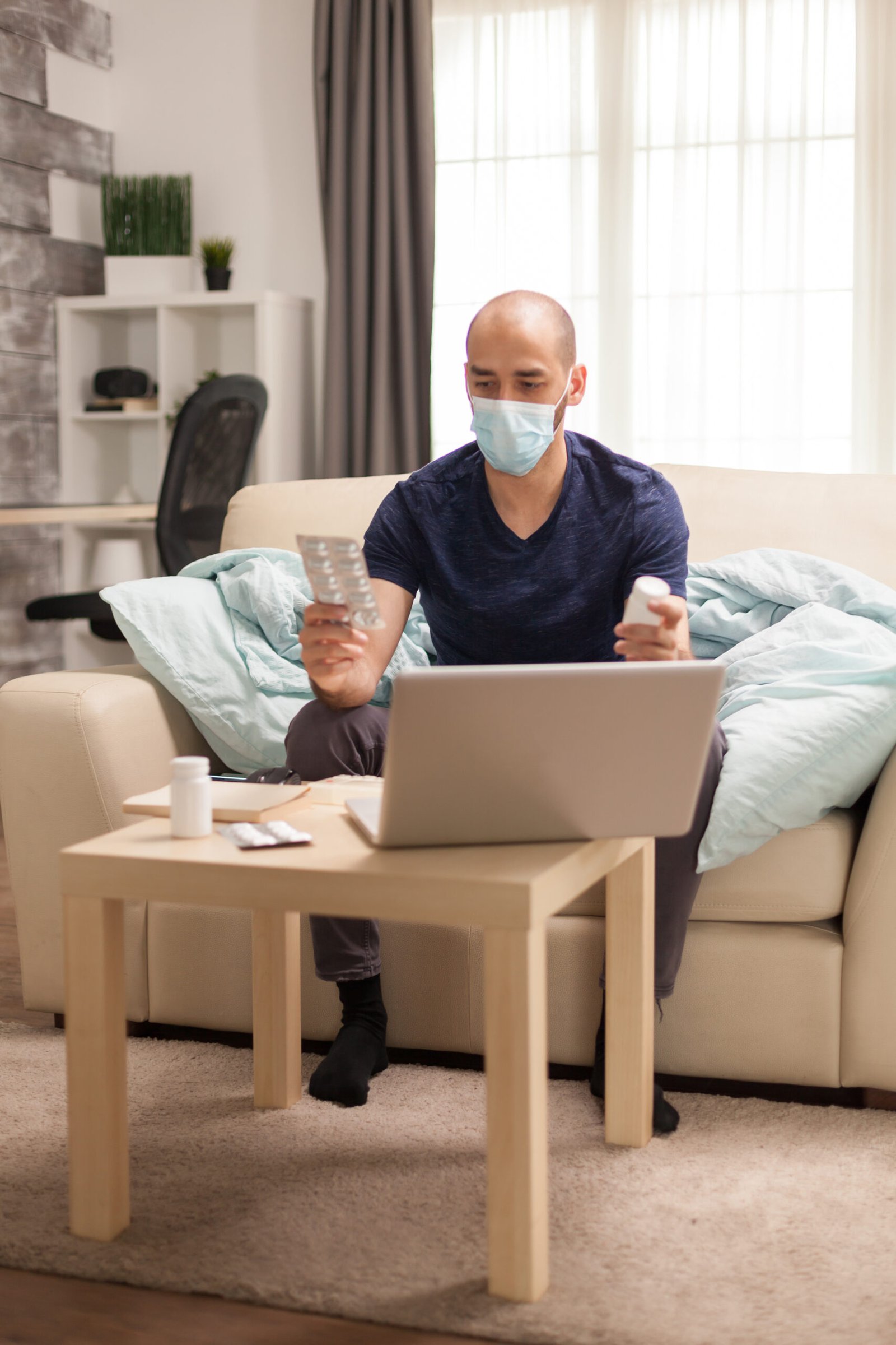 Man holding different pills during online doctor consultation, symbolizing the unlimited cancer risk and importance of medical guidance.