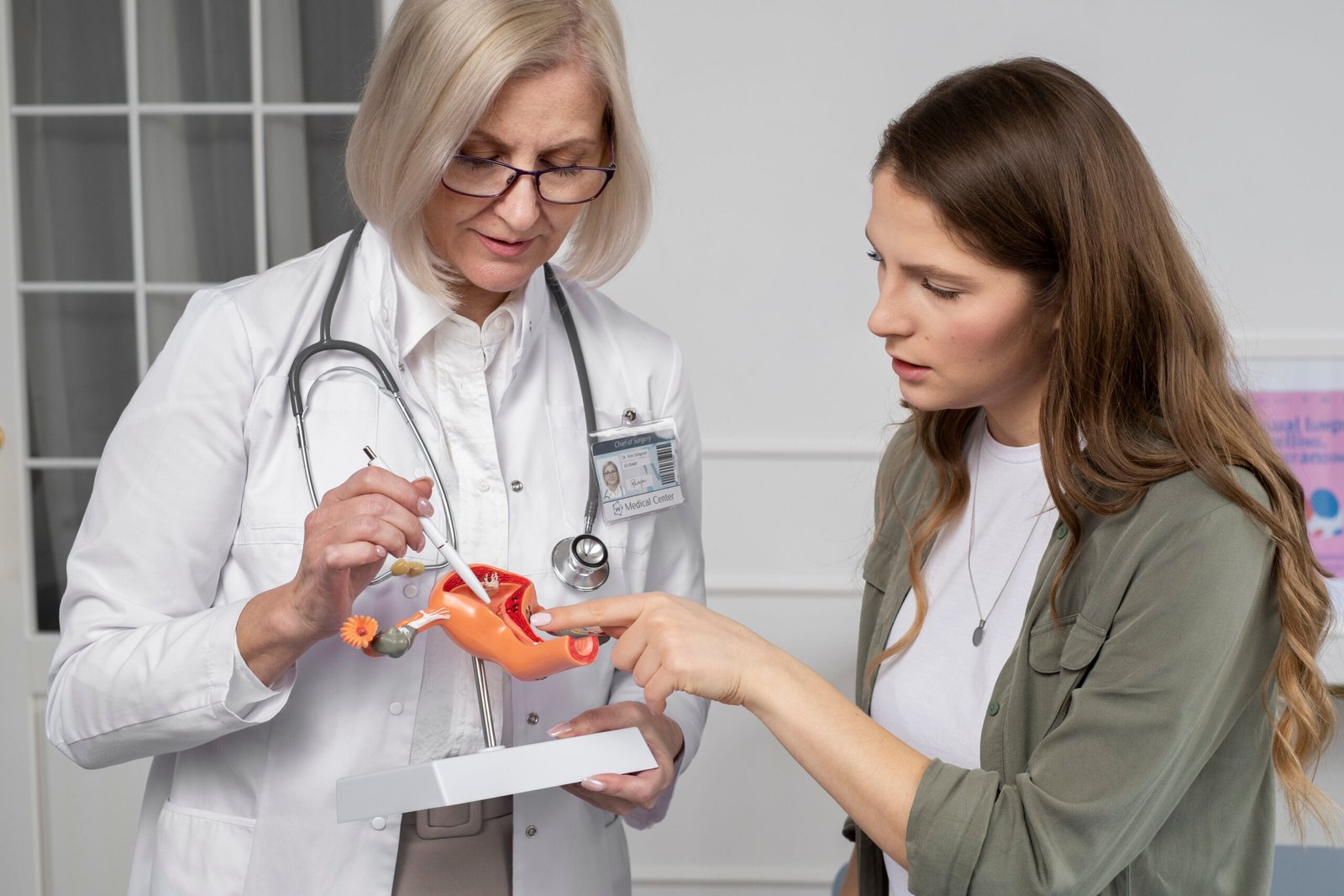 Female doctor discussing ovarian cancer chemotherapy treatment with patient during consultation.